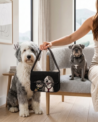 A woman is holding a handbag with a dog and a small dog sitting on a couch in a cozy living room.