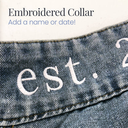 a pair of jeans with the words est 2 embroidered on them