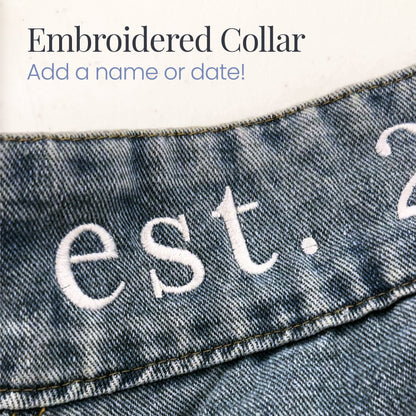 a pair of jeans with the words est 2 embroidered on them