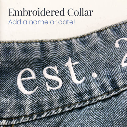 a pair of jeans with the words est 2 embroidered on them