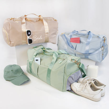 three colorful duffel bags, each with a different color and design, along with a green hat, a pair of white sneakers, and a pair of sunglasses.