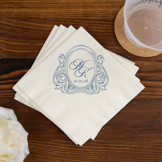 White napkins with decorative monogram and date on a wooden table.