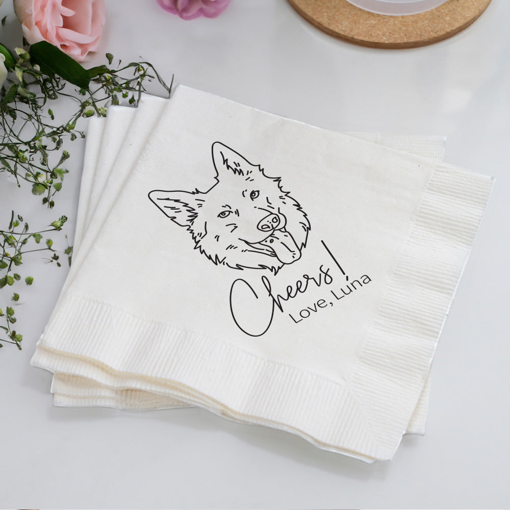 Stack of white napkins with a fox illustration and text on a light surface with flowers and a coaster.