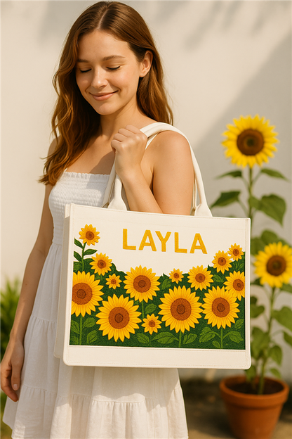 a woman holding a bag with a picture of sunflowers on it