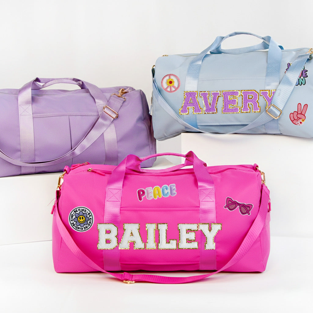 three colorful duffel bags, each with unique designs and names.