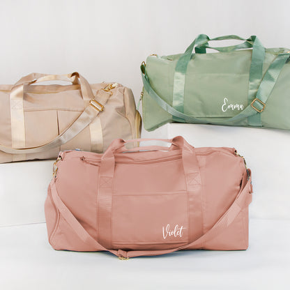 three colorful duffel bags, each with a unique color and name.