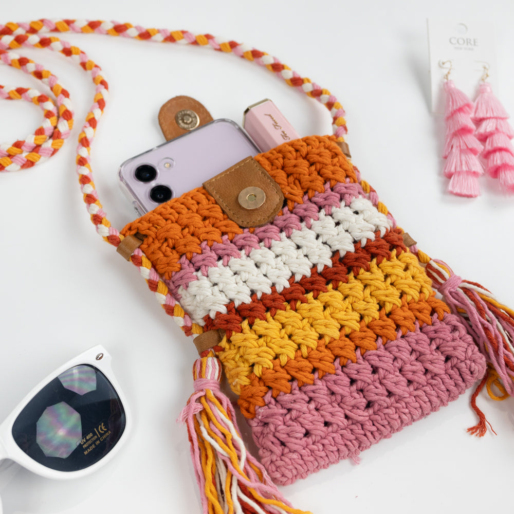 Boho-inspired Small Crossbody Cell Phone Purse, intricately crocheted in a stylish design. Measuring 5.25 in x 6.5 in x.5 in, it comfortably fits standard-sized phones and small essentials like a thin wallet or lip gloss. The 42 in strap allows it to drape effortlessly as a crossbody, secured with a sturdy leather magnetic snap closure. A chic and practical accessory, ideal for brides looking for a blend of function and fashion.