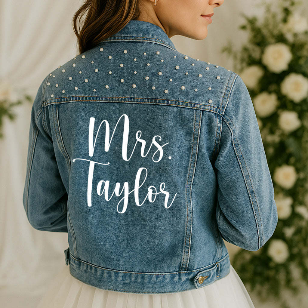 Denim jacket with 'Mrs. Taylor' on the back, floral background