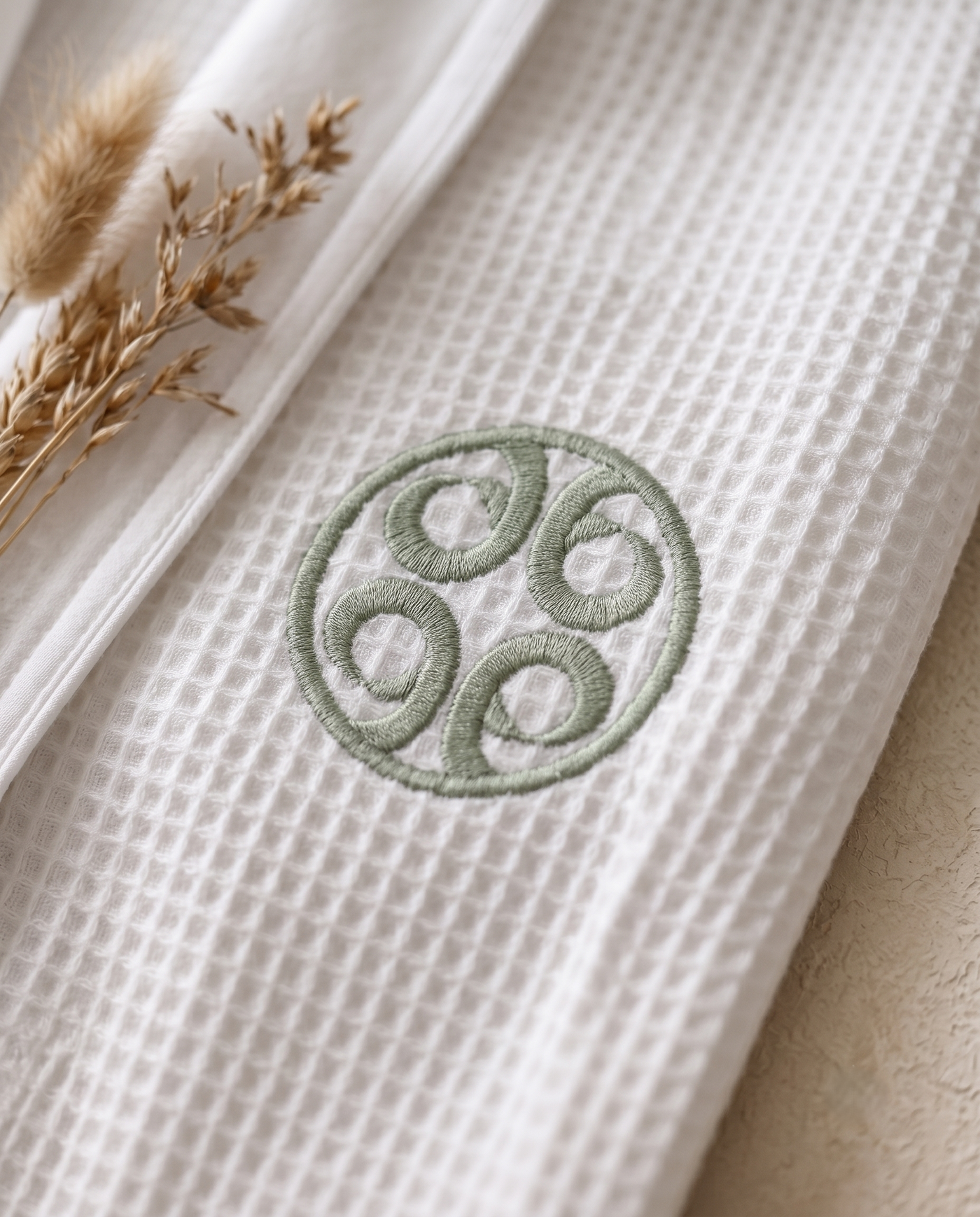 Satin robe with custom embroidered logo close-up