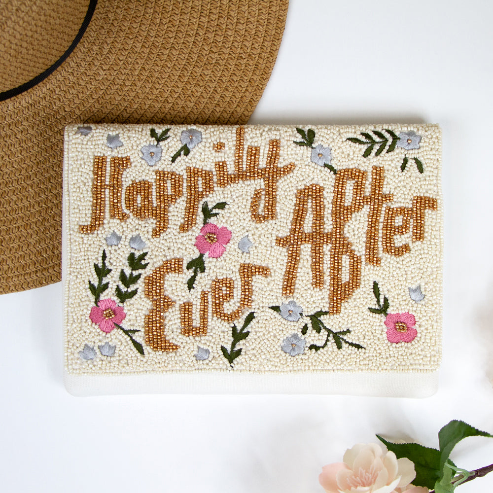 A handbag with a floral design and the text "Happily ever after" printed on it.