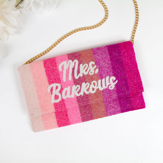 A colorful handbag with the name "Barkows" printed on it, sitting on a white surface.