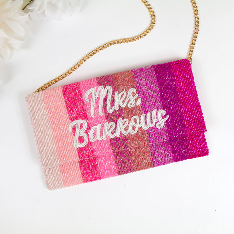 A colorful handbag with the name "Barkows" printed on it, sitting on a white surface.