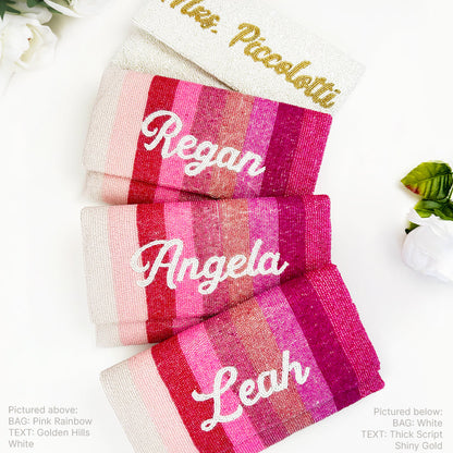three clutch bags with personalized names embroidered on them, arranged in a row.