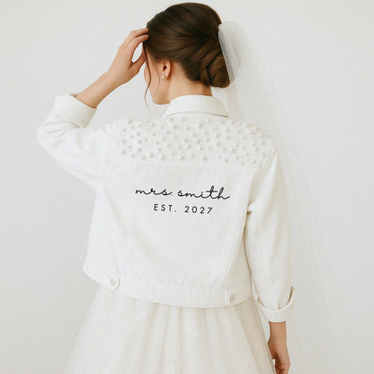 a woman in a white dress and a white jacket