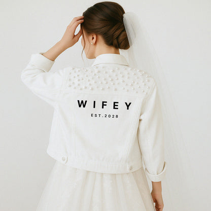 a woman in a white dress and a white jacket