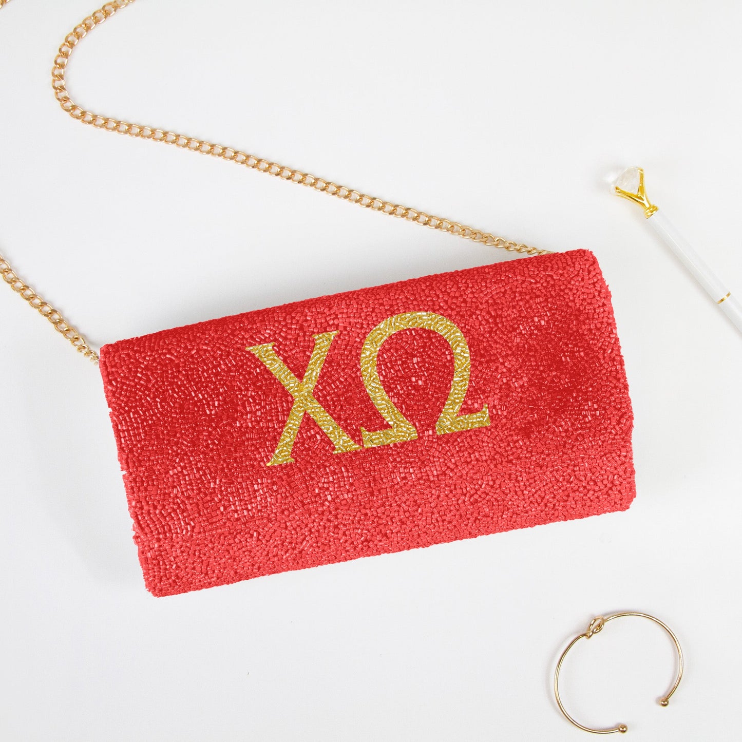 Elegant Personality Sorority Beaded Clutch Bag showcasing intricate beading patterns. Handcrafted to perfection, this clutch offers both style and function for weddings and special events. Features a customizable date inside, and an option for a gold or silver chain. Measuring at 9.5in x 5in x 3in, it's spacious enough for essentials while retaining a sophisticated silhouette. Each clutch celebrates unique craftsmanship, ensuring every piece is a one-of-a-kind accessory."