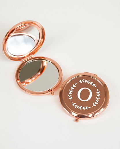 Rose gold mirror compact with her initial in a laurel wreath