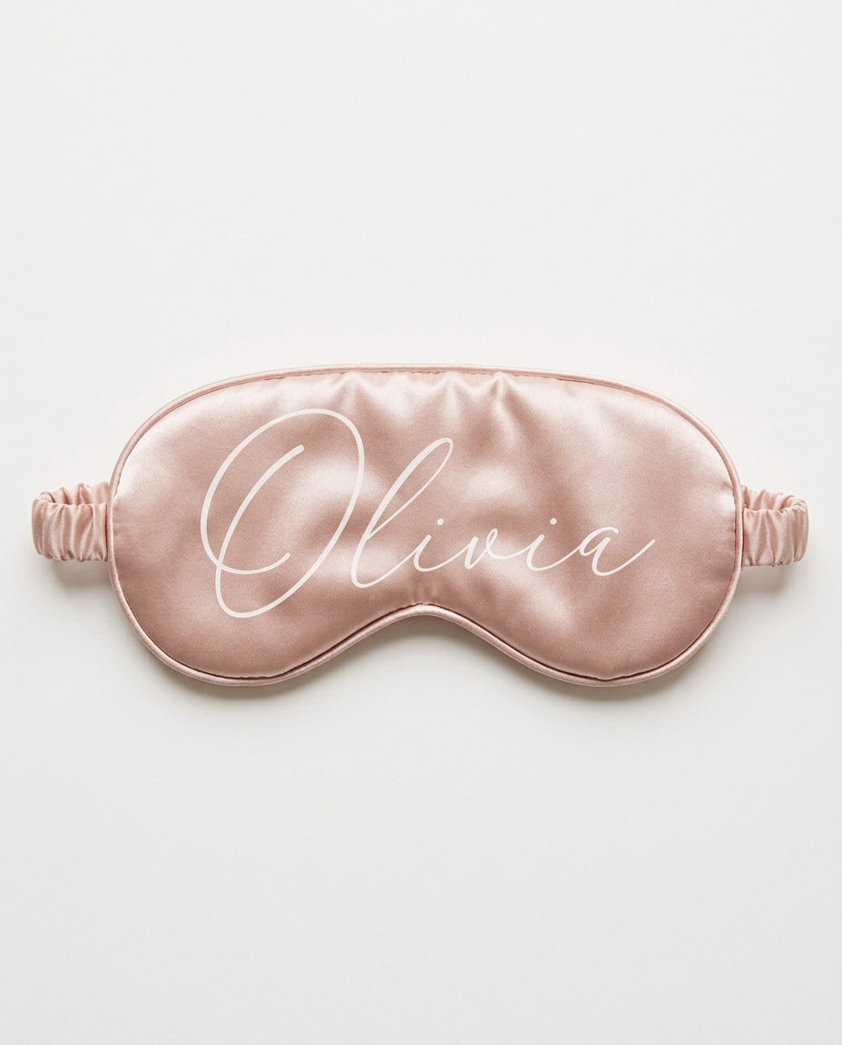 Blush satin eye mask with her name printed in white script