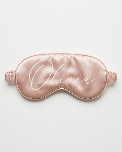 Blush satin eye mask with her name printed in white script