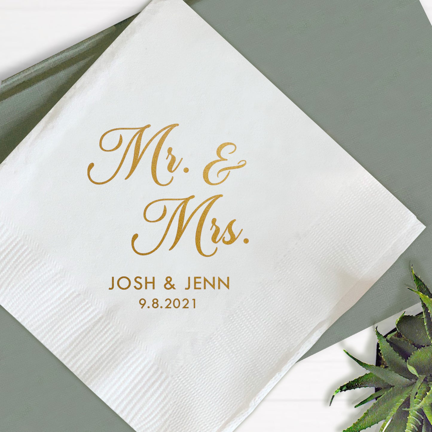 A folded white paper napkin with 'Mr. & Mrs.
