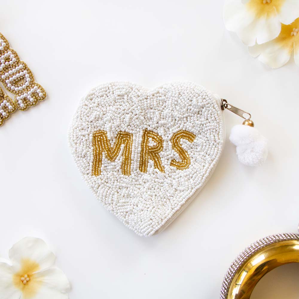 Exquisite Mrs. Coin Bridal Clutch, hand-beaded to perfection in a blend of matte white and shimmering gold. Ideal for weddings and special occasions, this durable canvas purse with a secure zipper elegantly complements any outfit. A perfect keepsake or gift for brides, capturing the uniqueness of artisanal craftsmanship.