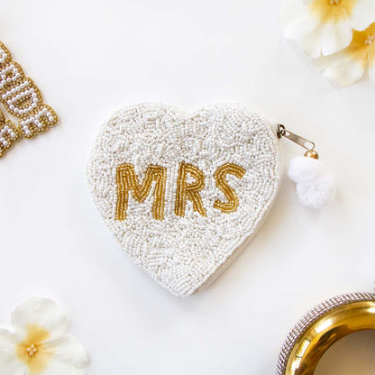 Exquisite Mrs. Coin Bridal Clutch, hand-beaded to perfection in a blend of matte white and shimmering gold. Ideal for weddings and special occasions, this durable canvas purse with a secure zipper elegantly complements any outfit. A perfect keepsake or gift for brides, capturing the uniqueness of artisanal craftsmanship.