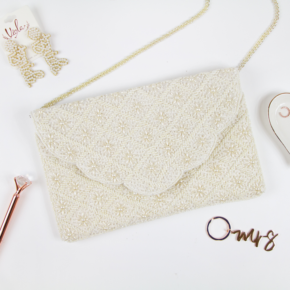 Elegant Bridal Clutch: Plain White Scallop Pearl Clutch Bag measuring 6.5 x 10 x 1in. Crafted from durable canvas with a magnetic snap closure and detailed with intricate gold beading. Each handcrafted clutch offers a unique design, perfect for brides seeking an exceptional accessory for their special day.