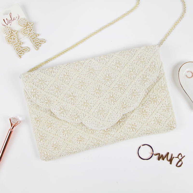 Elegant Bridal Clutch: Plain White Scallop Pearl Clutch Bag measuring 6.5 x 10 x 1in. Crafted from durable canvas with a magnetic snap closure and detailed with intricate gold beading. Each handcrafted clutch offers a unique design, perfect for brides seeking an exceptional accessory for their special day.